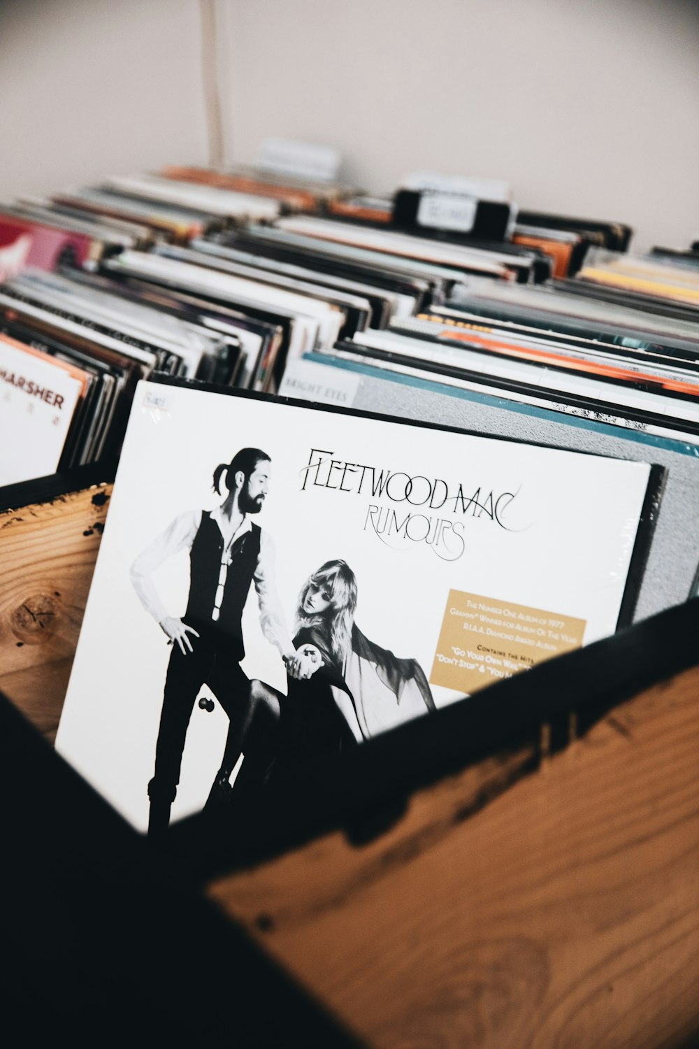 a collection of cd's sitting on top of a wooden table