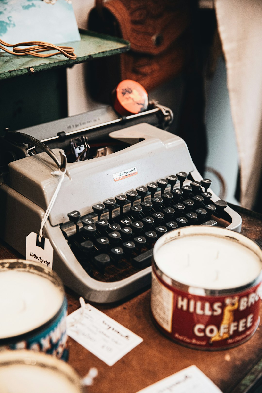 black and white typewriter beside white and red plastic cup