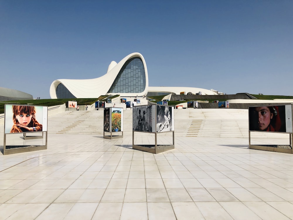 people walking on white concrete floor under blue sky during daytime