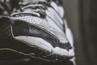 Close-up of a rugged, well-used sports shoe with visible stitching and grip.