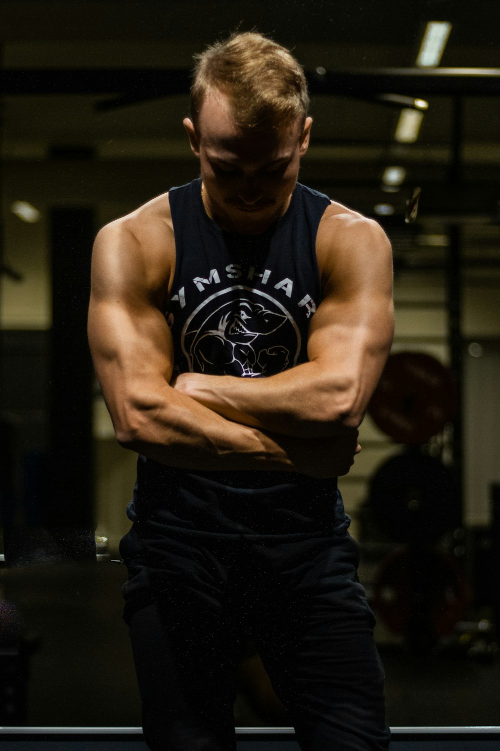 man in black tank top and black pants