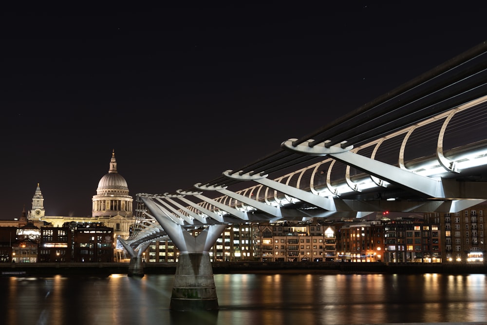 white bridge over body of water during night time