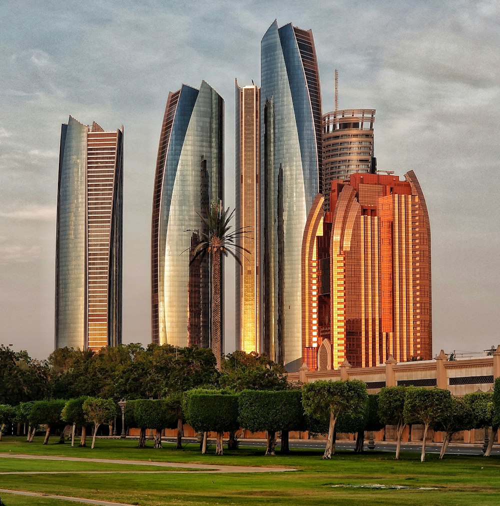 green grass field near high rise buildings during daytime