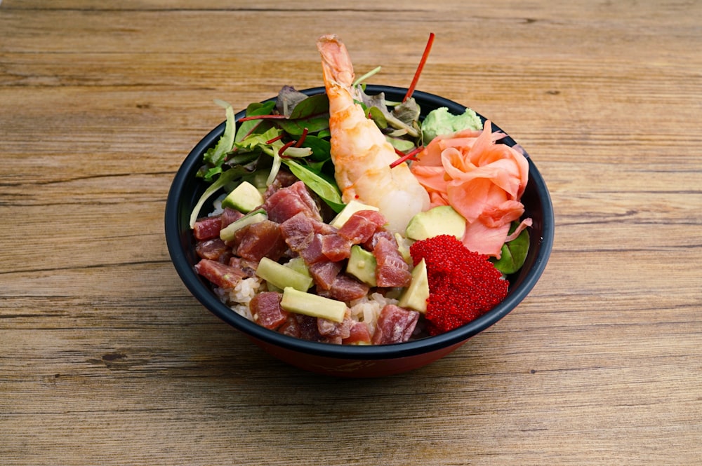 a bowl of food on a wooden table