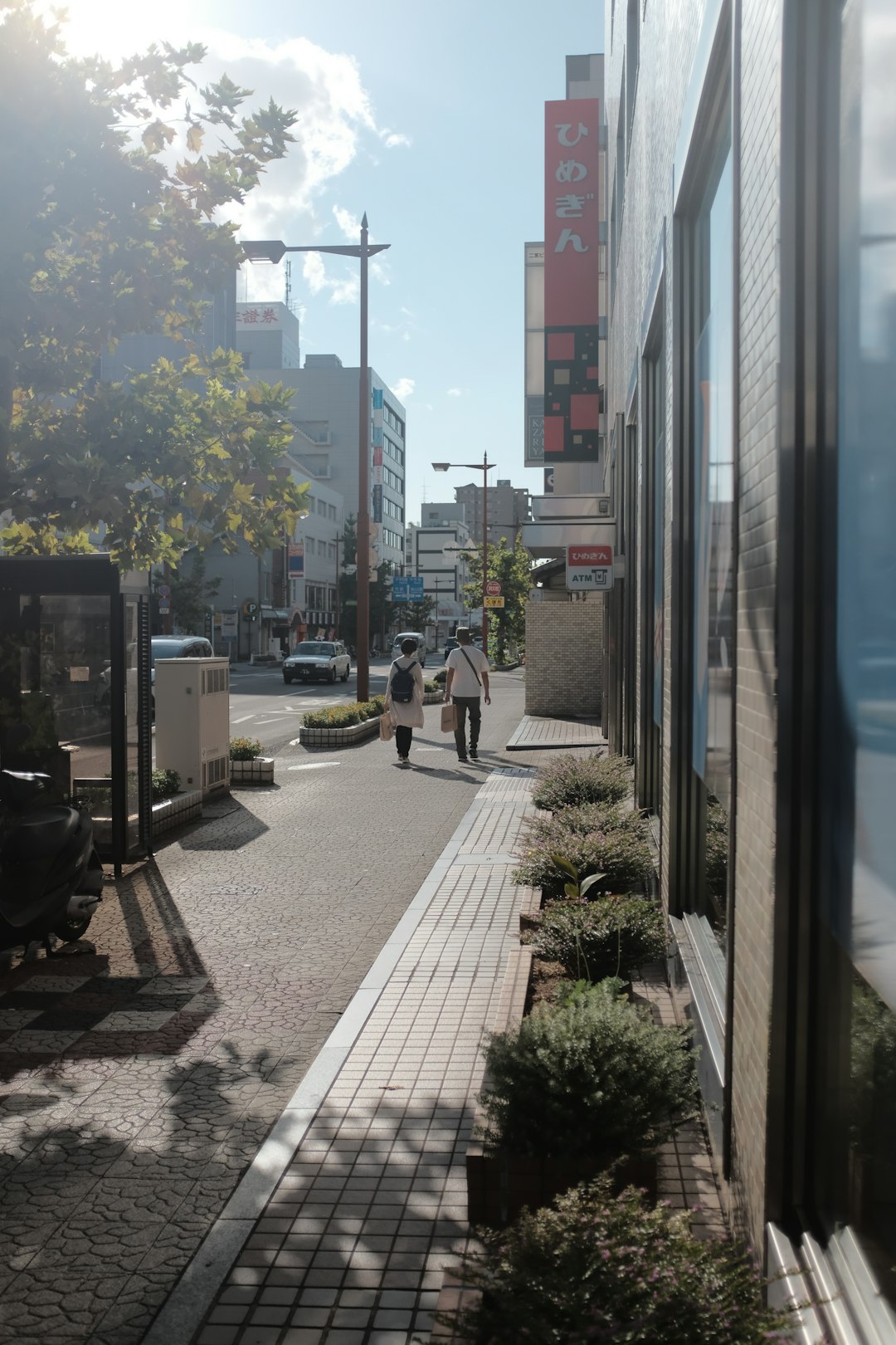 cars parked on sidewalk near buildings during daytime