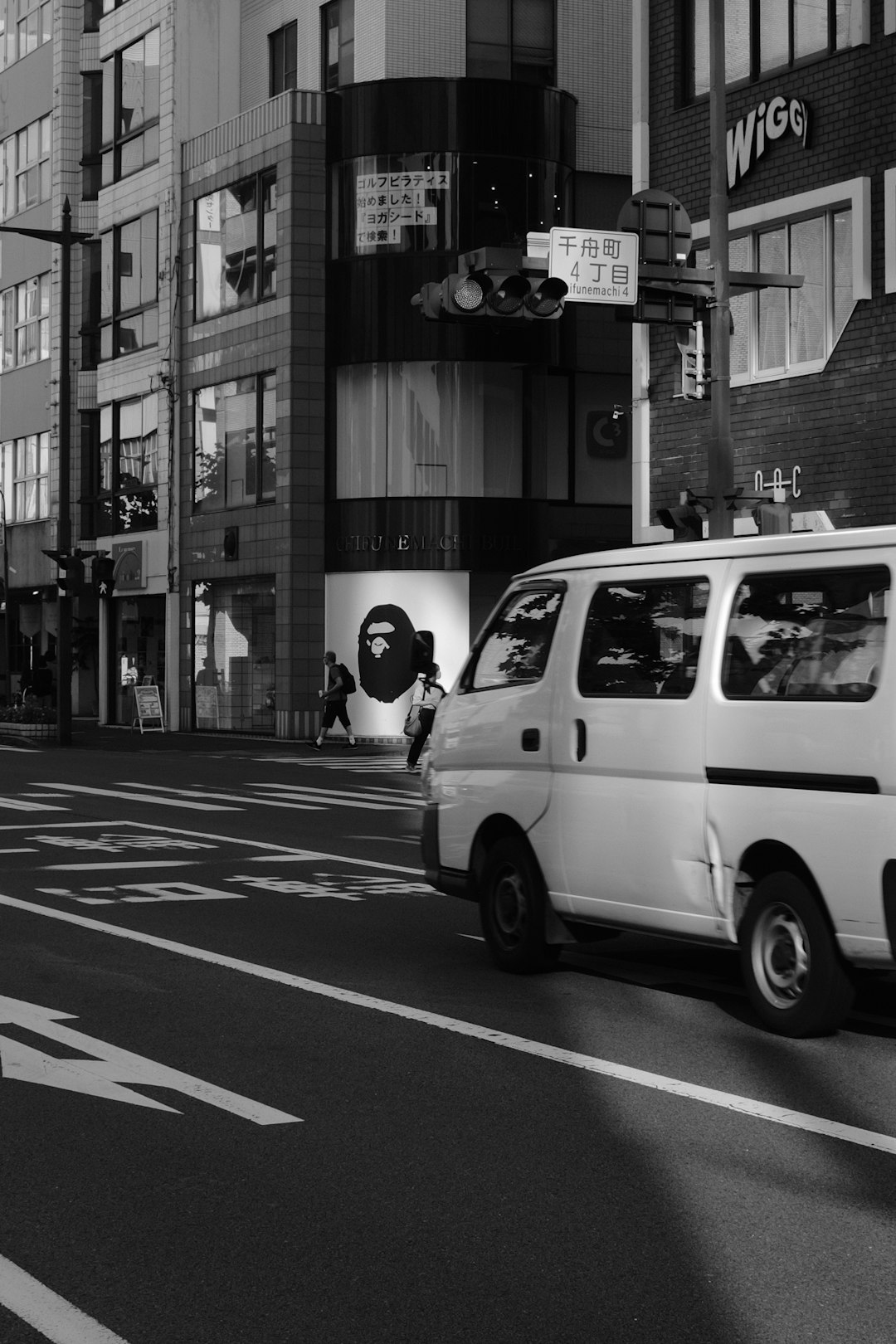grayscale photo of white van on road