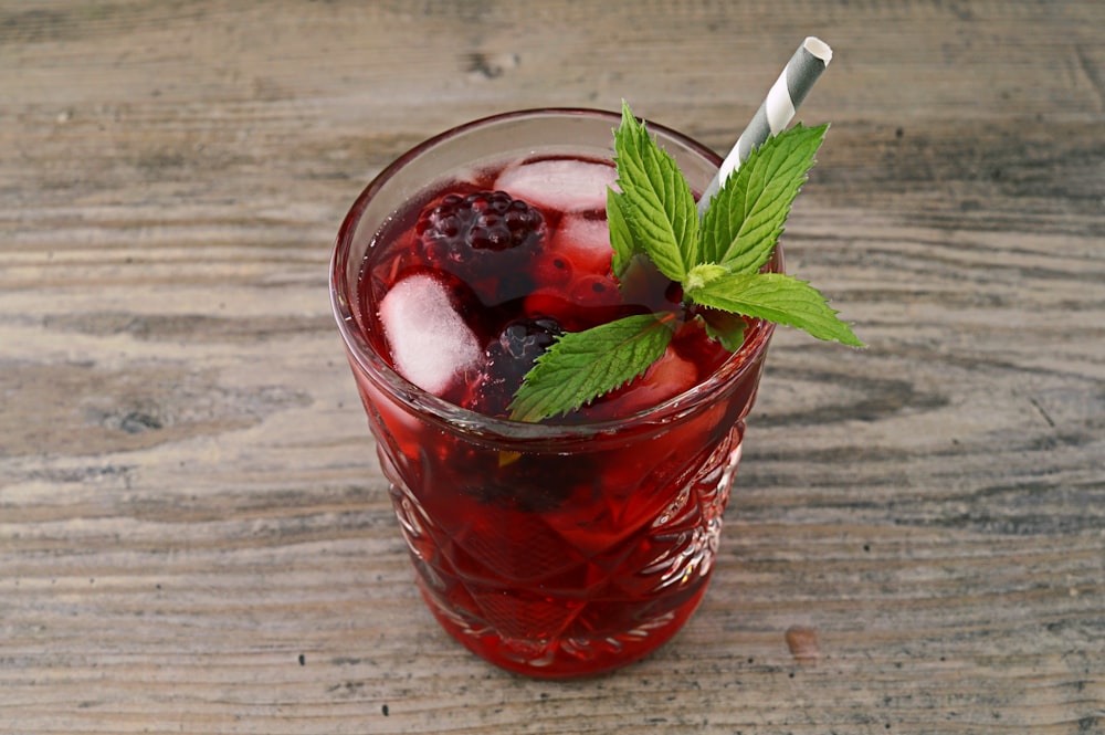 a glass of ice tea with a mint garnish
