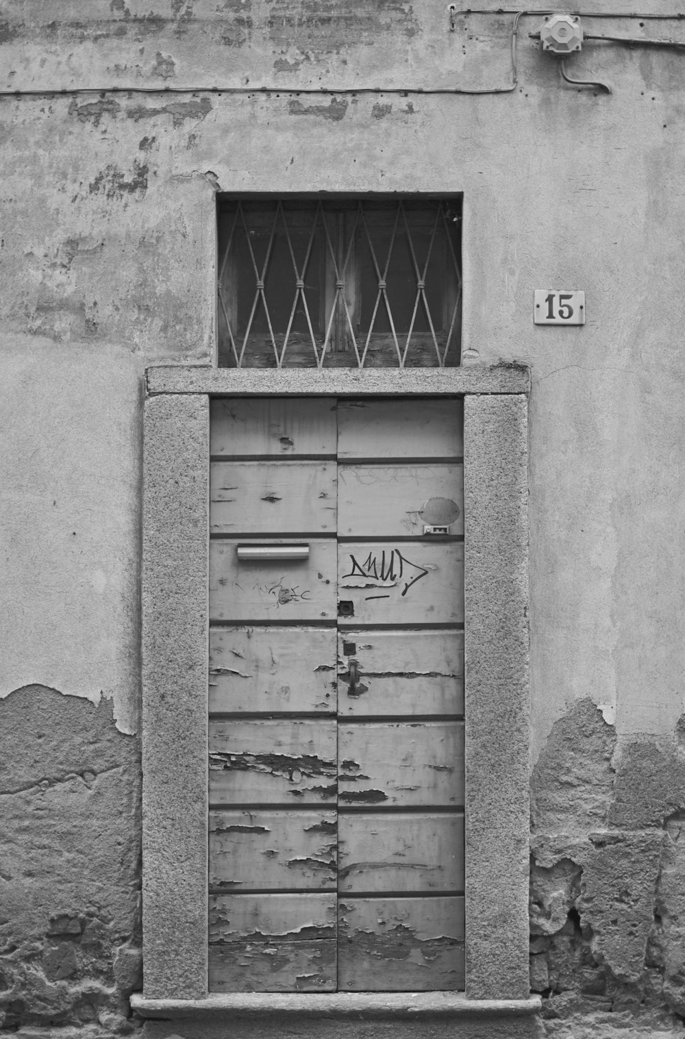 grayscale photo of wooden door