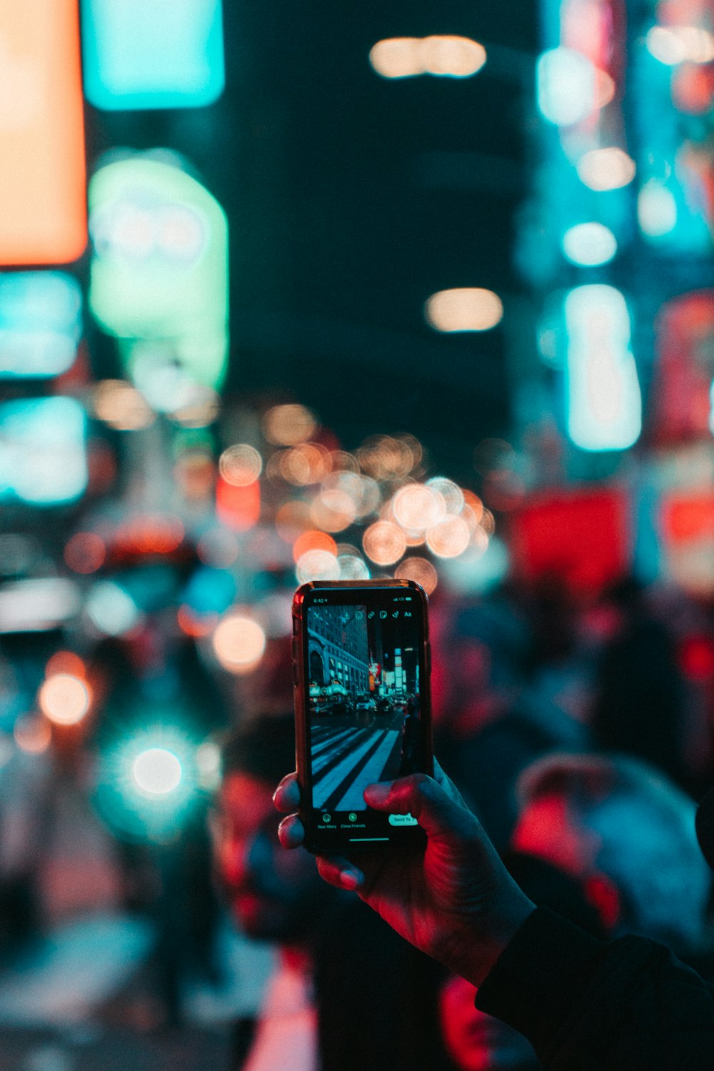 person taking photo of city during night time