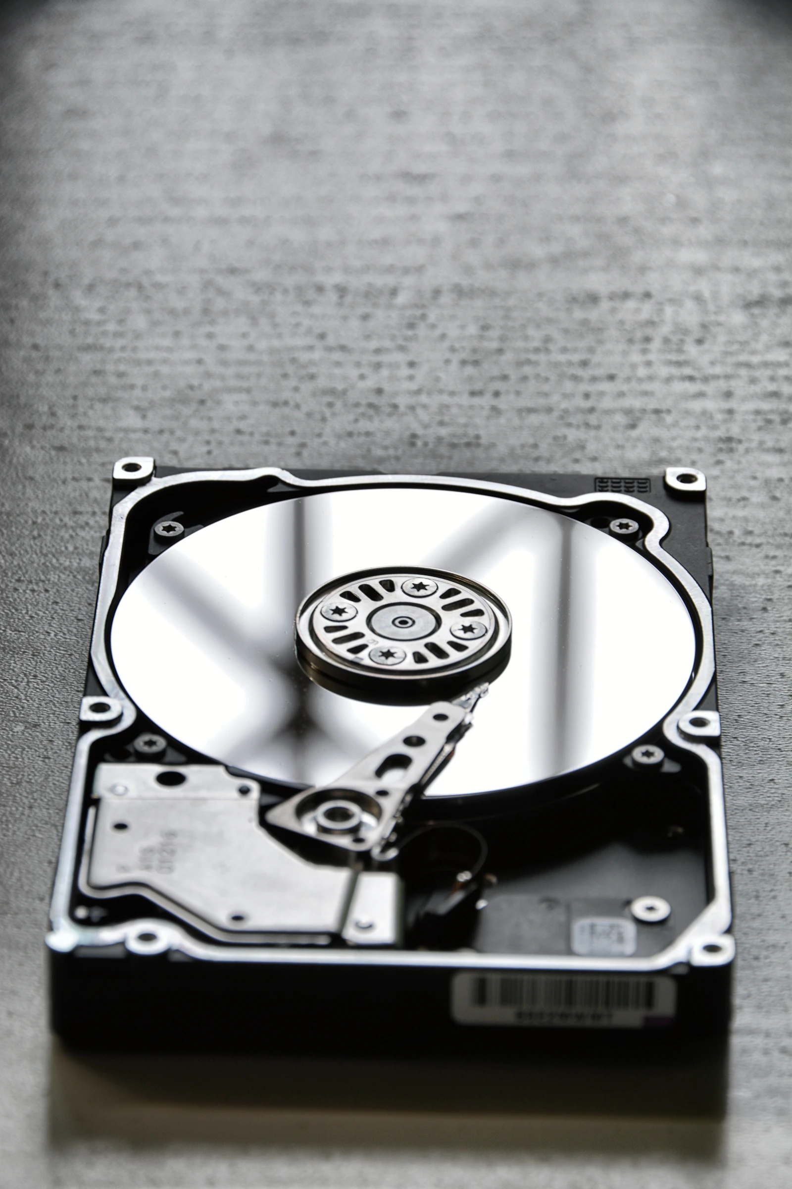 Open 3.5-inch hard disk drive showing platter, spindle, and actuator arm—the physical disks JBOD presents one-by-one