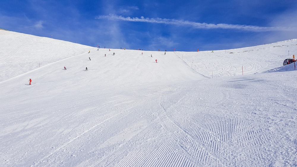 people riding ski lift on snow covered mountain during daytime