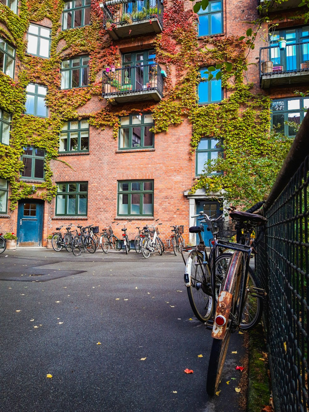 bicycles parked on sidewalk near brown building during daytime