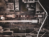 Wide aerial view of industrial steel building complex.