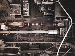 Wide aerial view of industrial steel building complex.