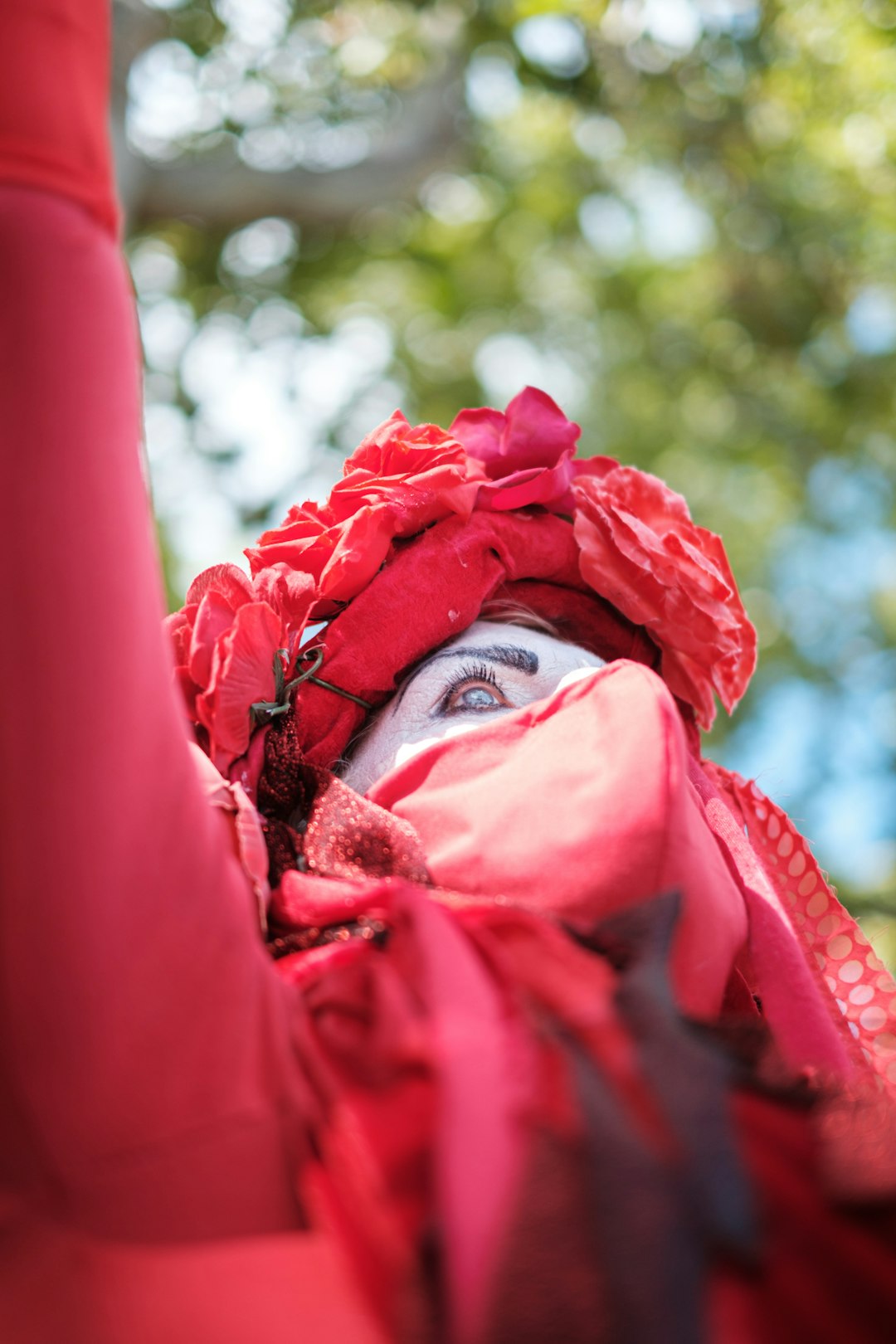 woman in red hijab covering her face with red textile