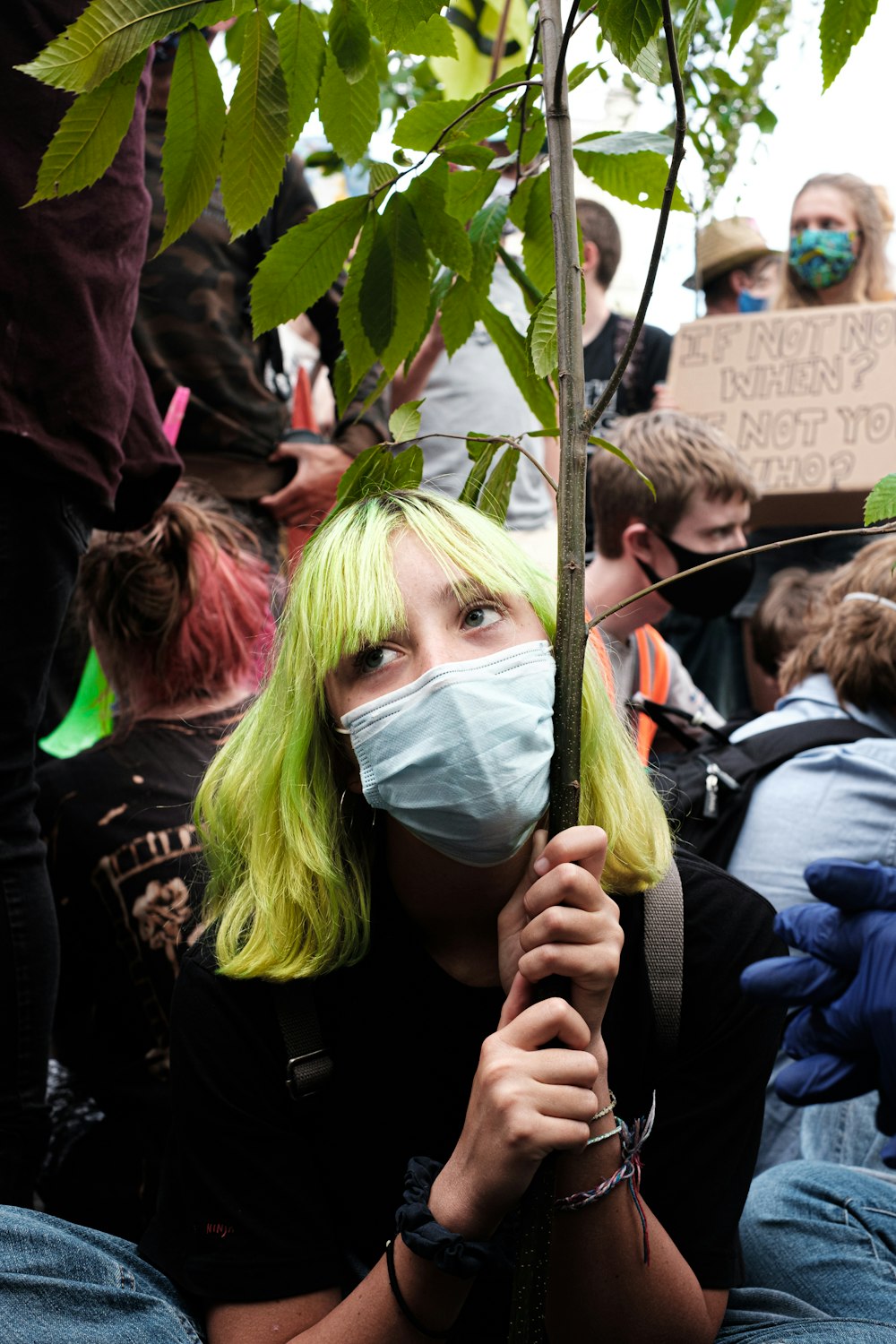 woman with green hair wearing black long sleeve shirt