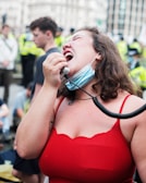 Close-up of a woman speaking passionately into a microphone during an International Women's Day event.