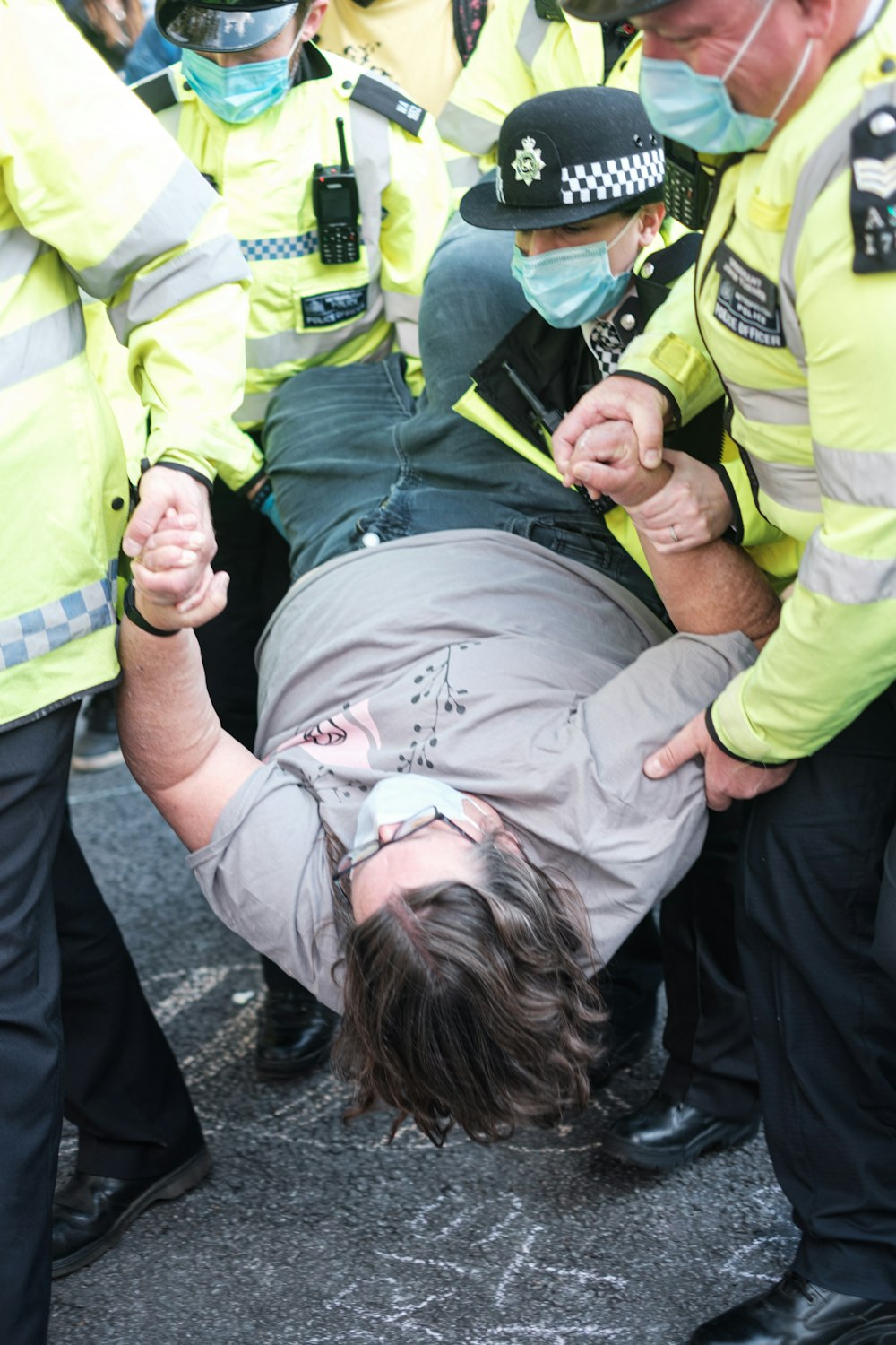 man in green jacket lying on ground beside man in green jacket