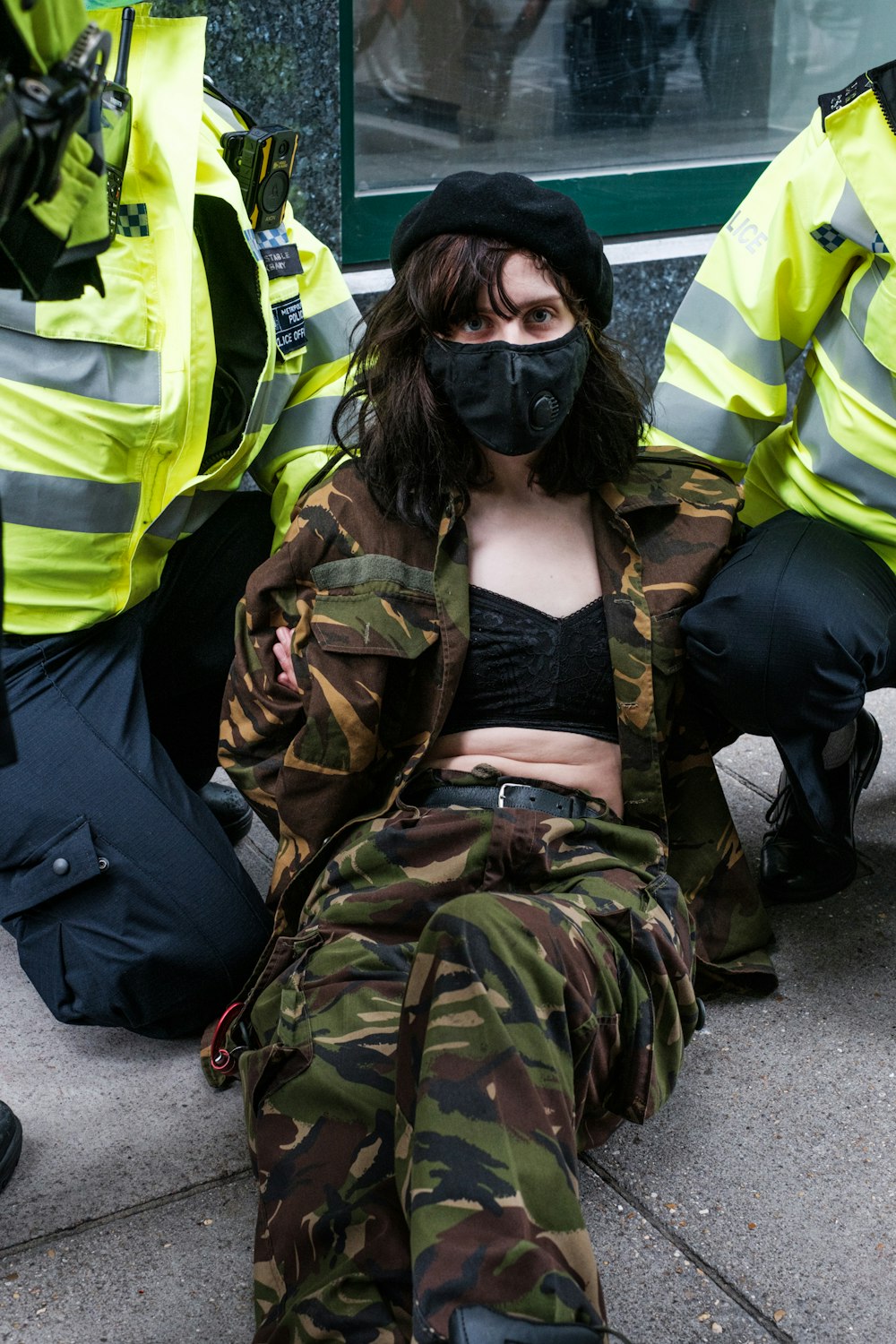 man in green and brown camouflage jacket wearing black mask