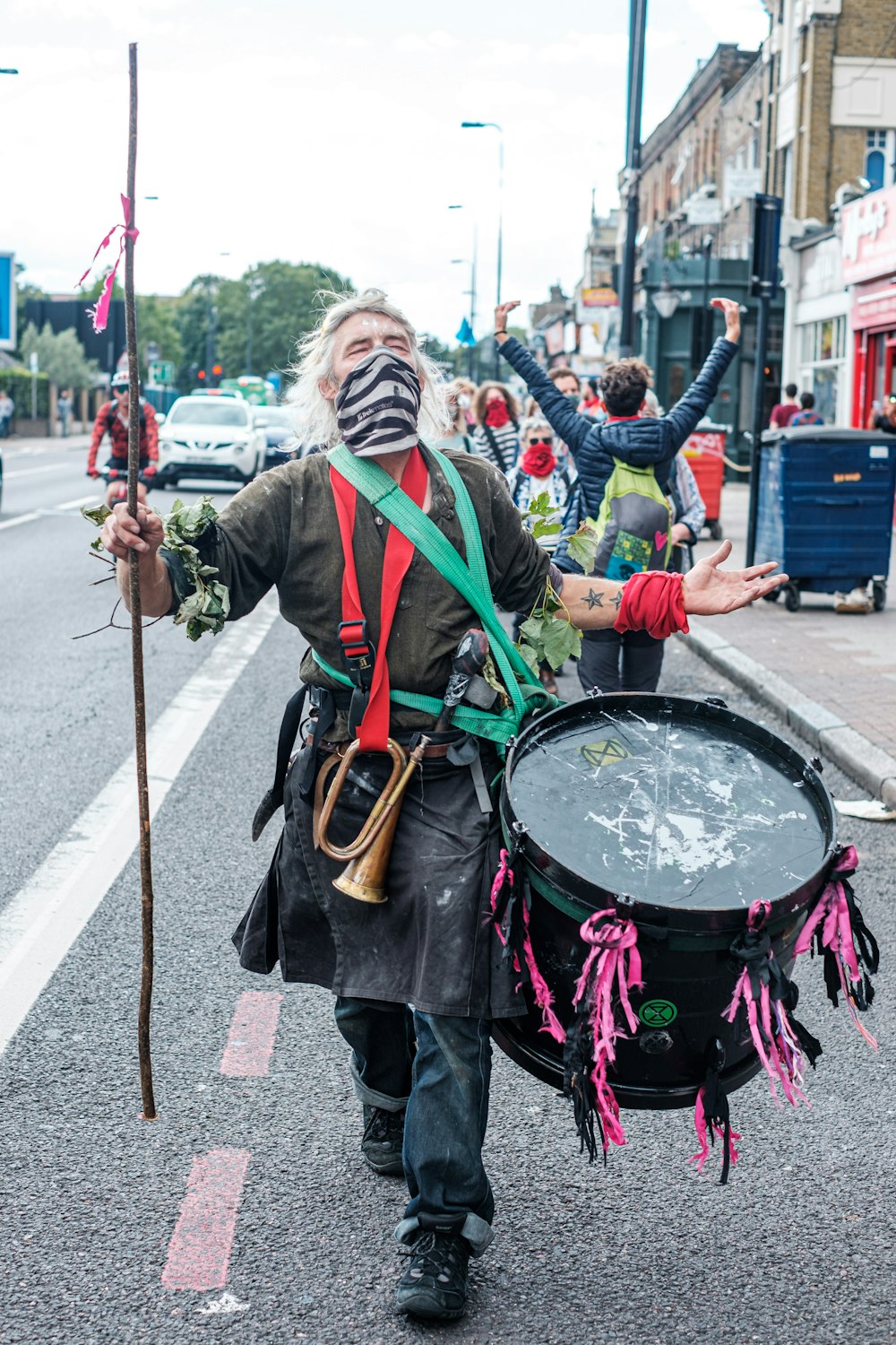 man in green jacket playing drum