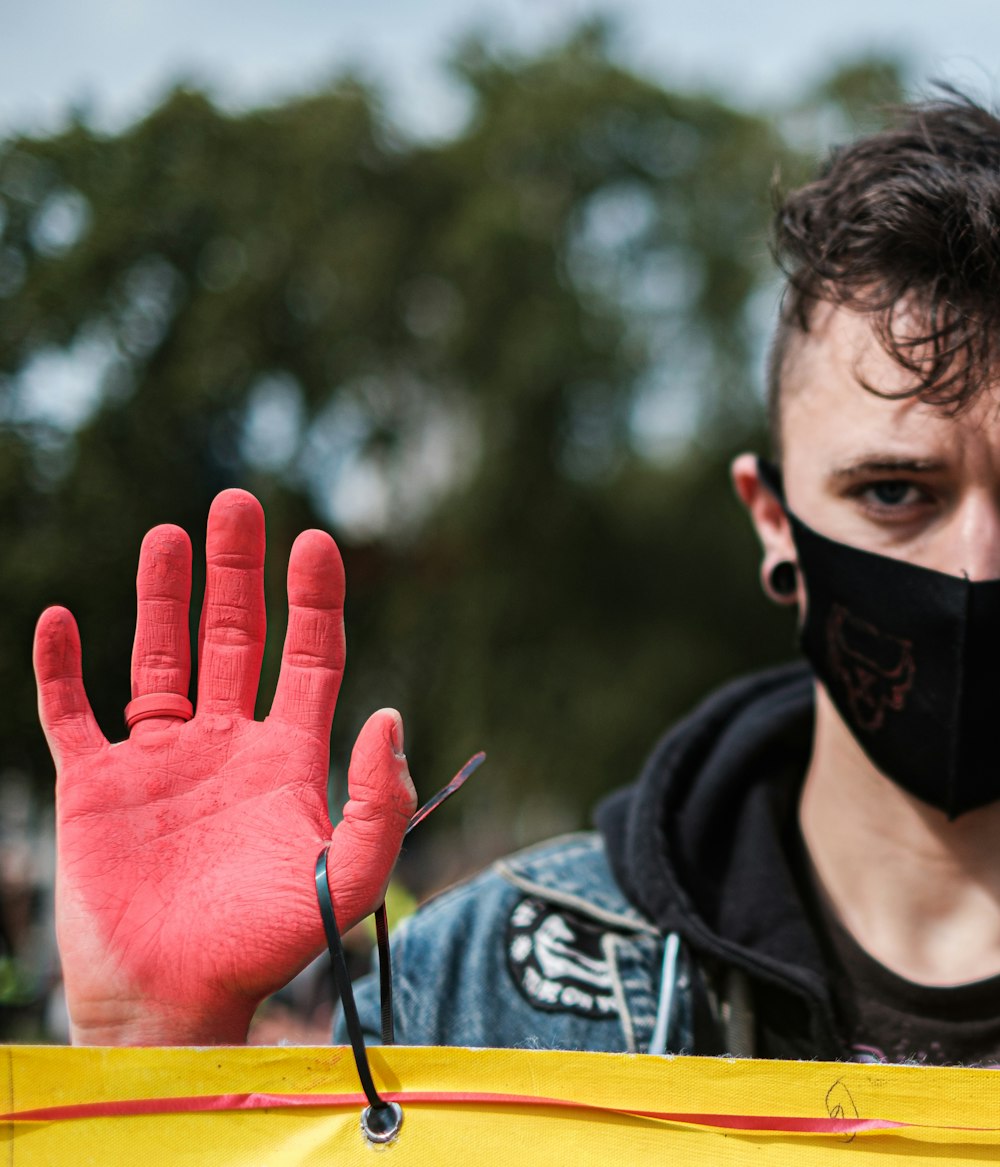 man in black and white hoodie wearing black mask