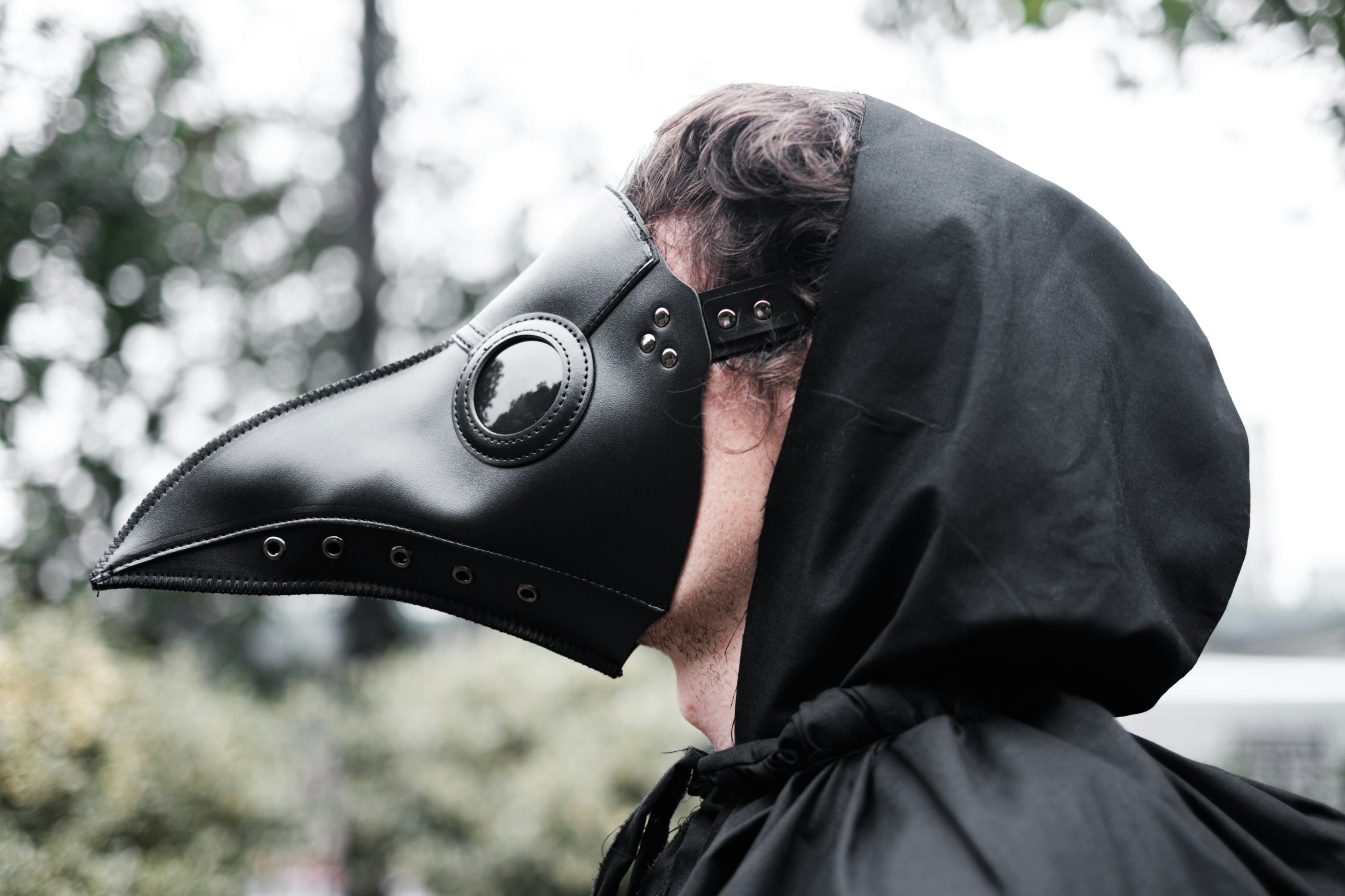 man in black hoodie wearing black leather mask
