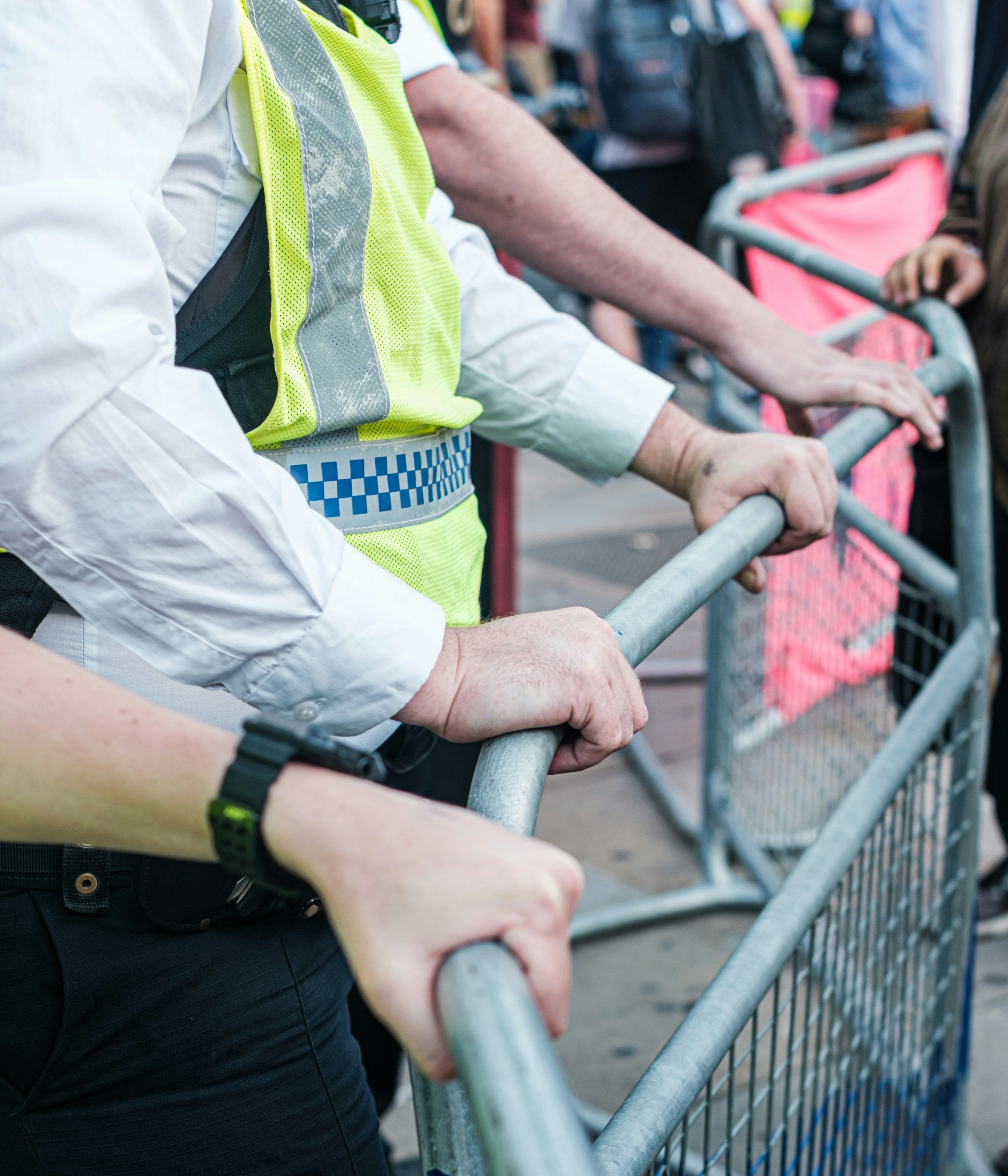 a guard controlling a crowd through barricades