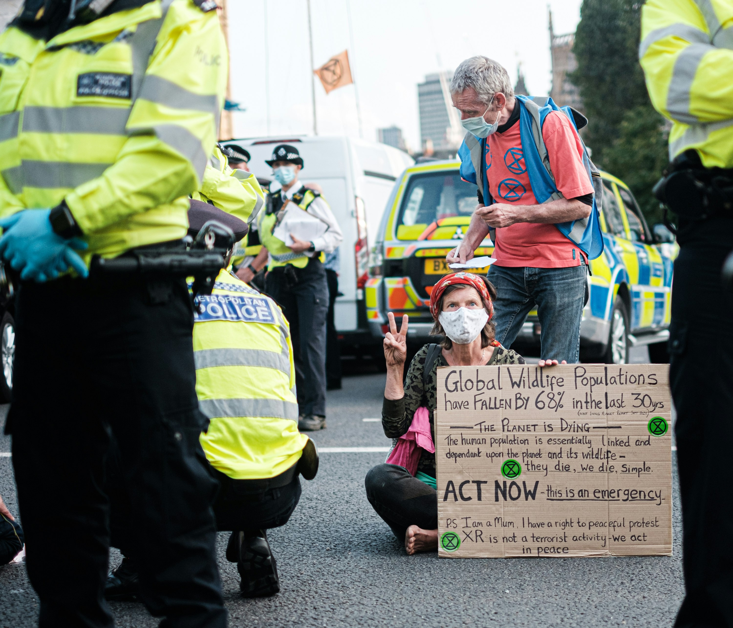 man in green jacket holding brown cardboard box