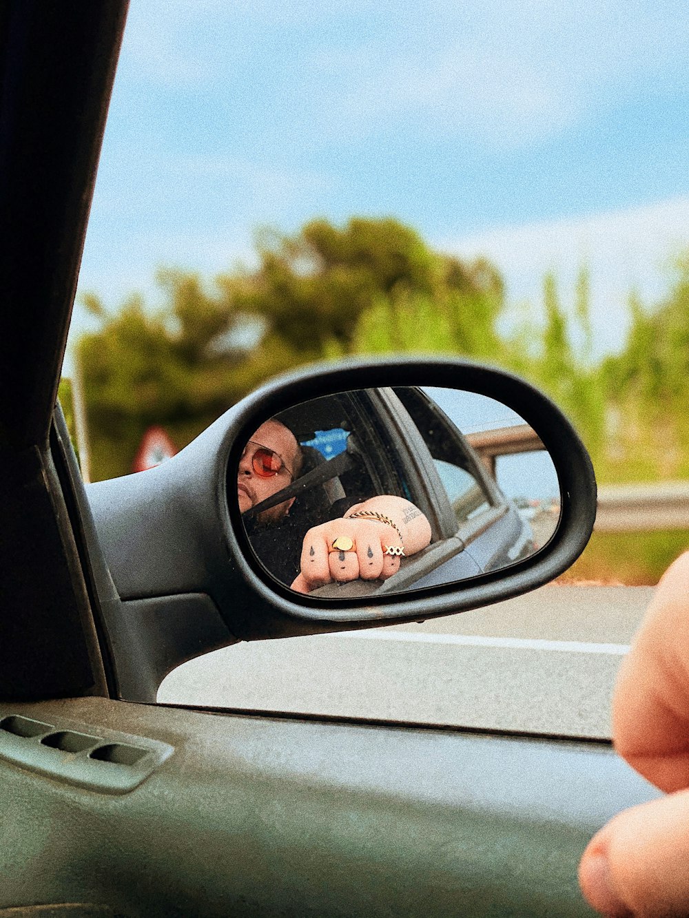 person driving car on road during daytime