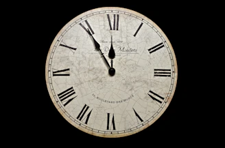 white and black analog clock at 10 10