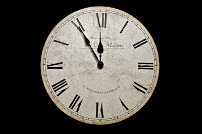 white and black analog clock at 10 10