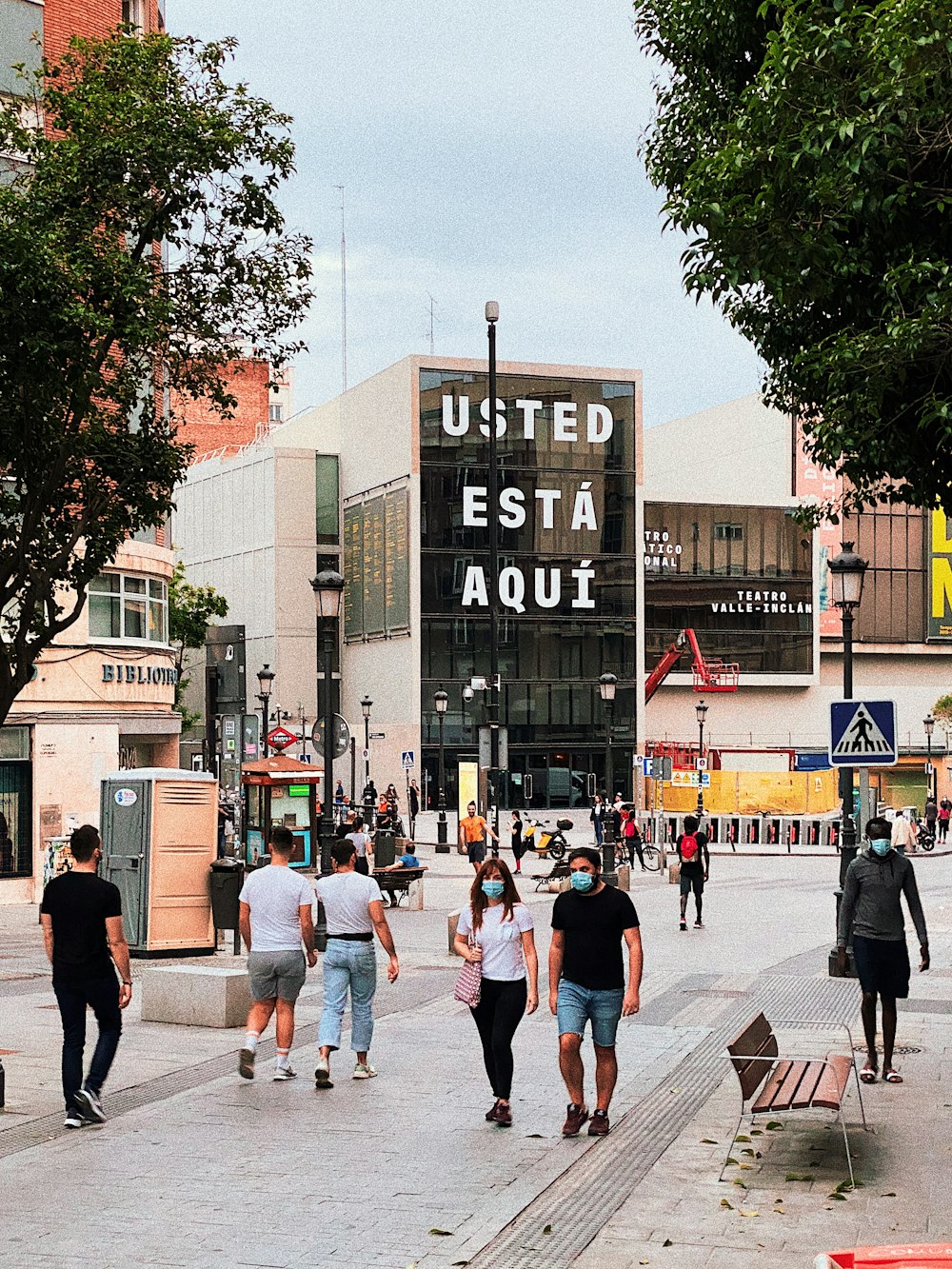 people walking on sidewalk near building during daytime