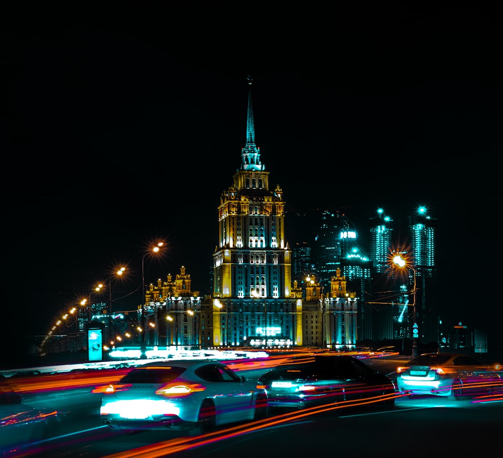 cars on road near buildings during night time