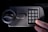 A hand presses the number 0 on an electronic keypad. The keypad is attached to a grey safe with a round handle and the words EASY HOME written above the keypad.
