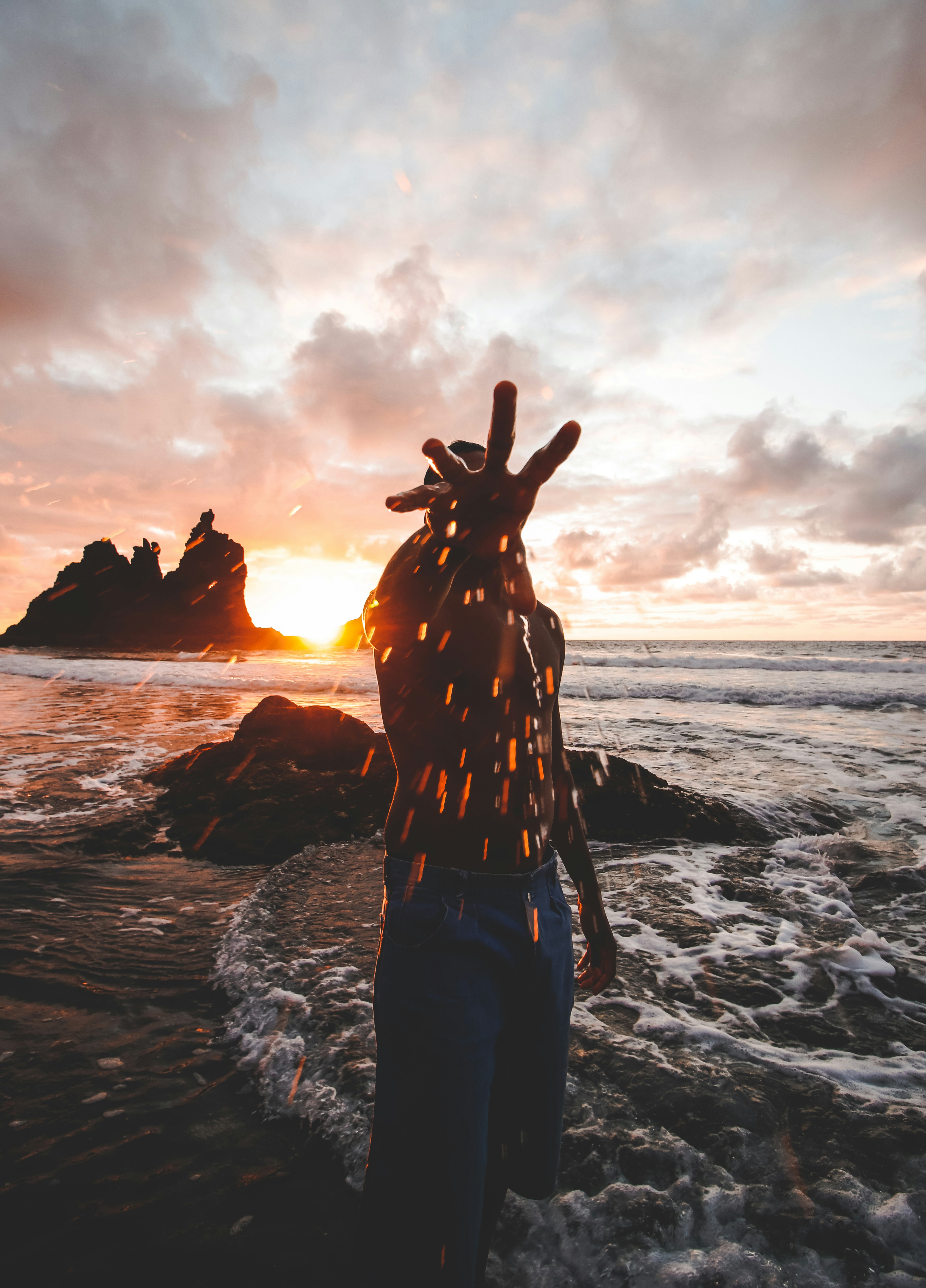 person standing on seashore during sunset
