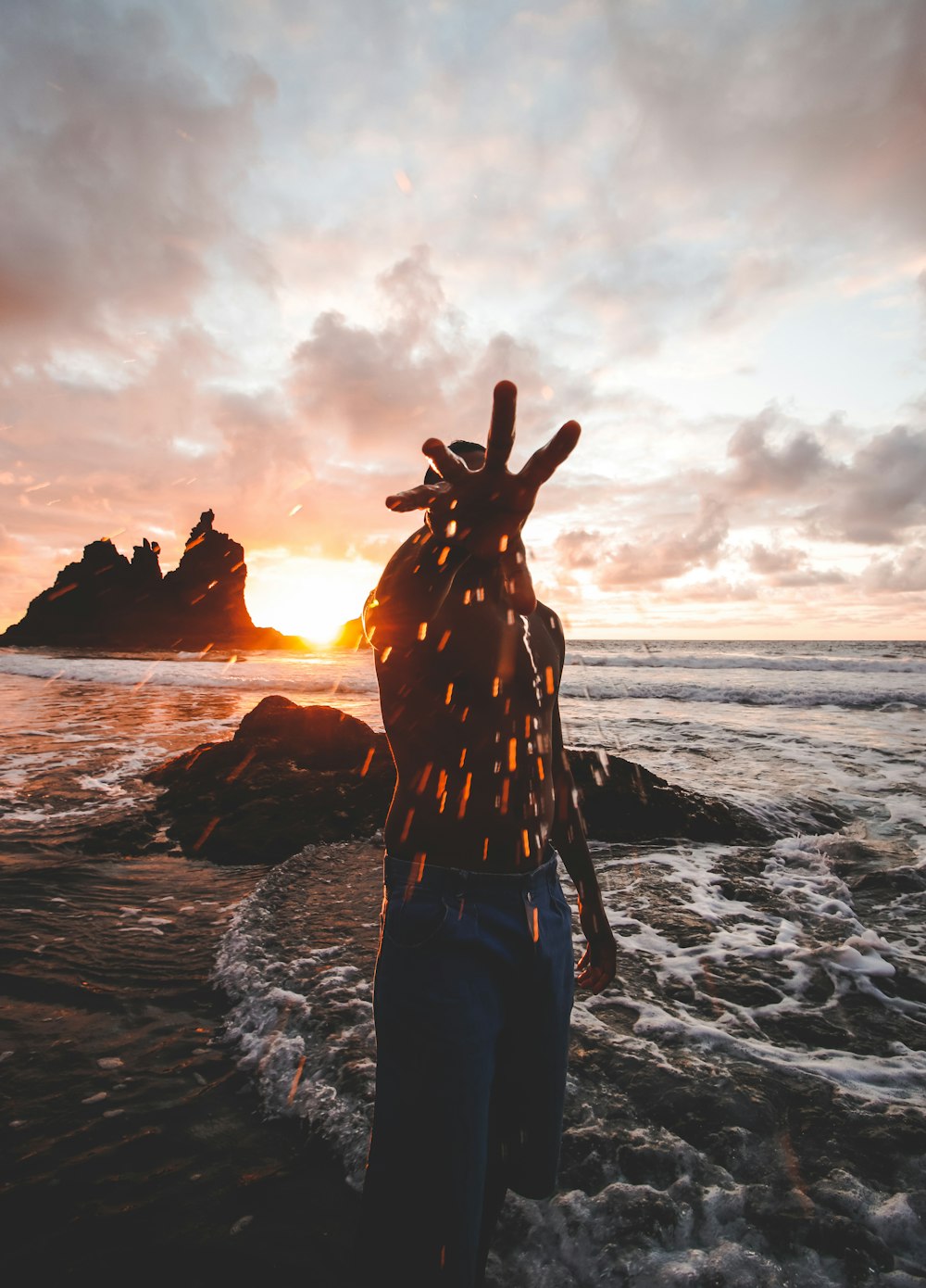 woman in black and white dress standing on seashore during sunset