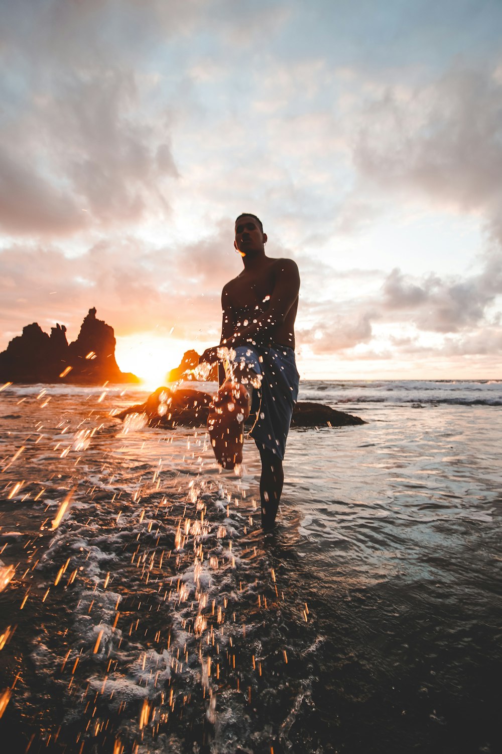 woman in black dress standing on seashore during sunset