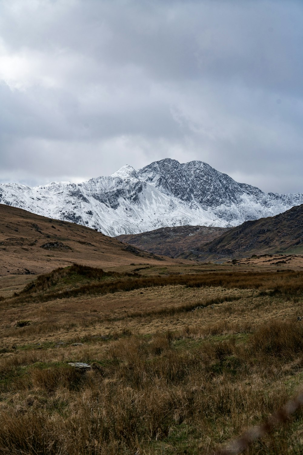 white and black mountains under white cloudy sky during daytime