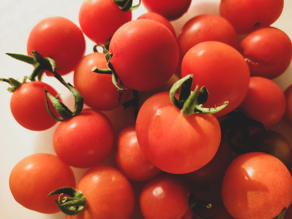 red tomato fruit on green surface