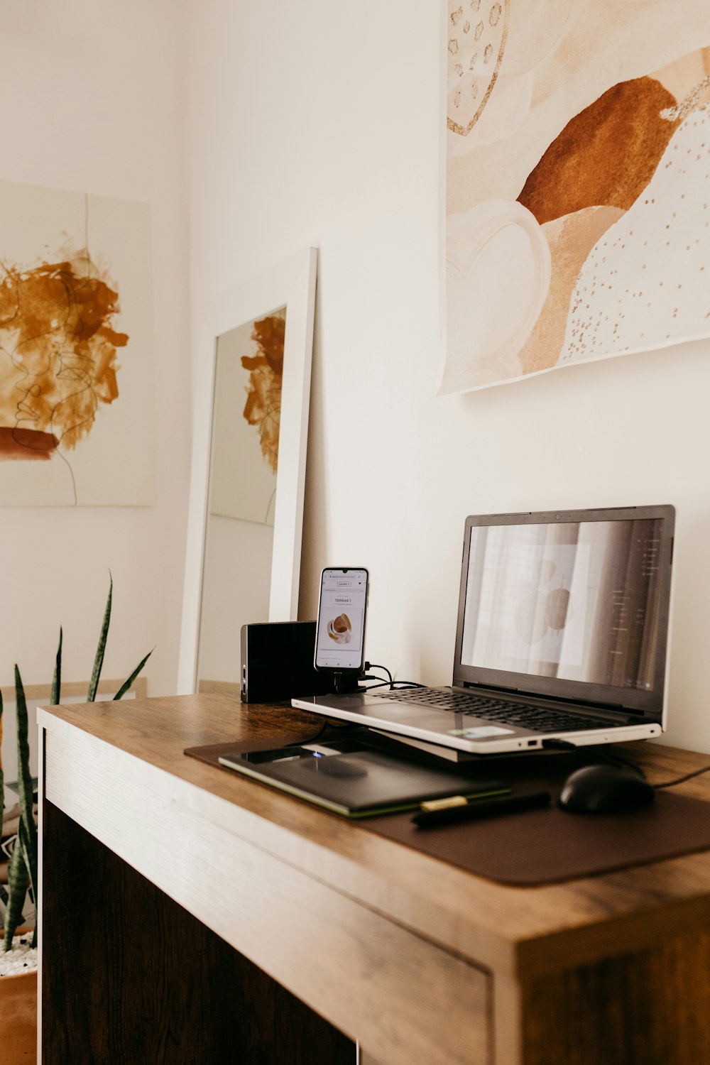 black laptop computer on brown wooden desk