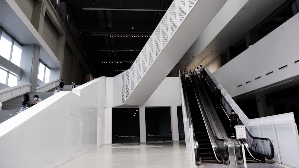 white and black escalator inside building