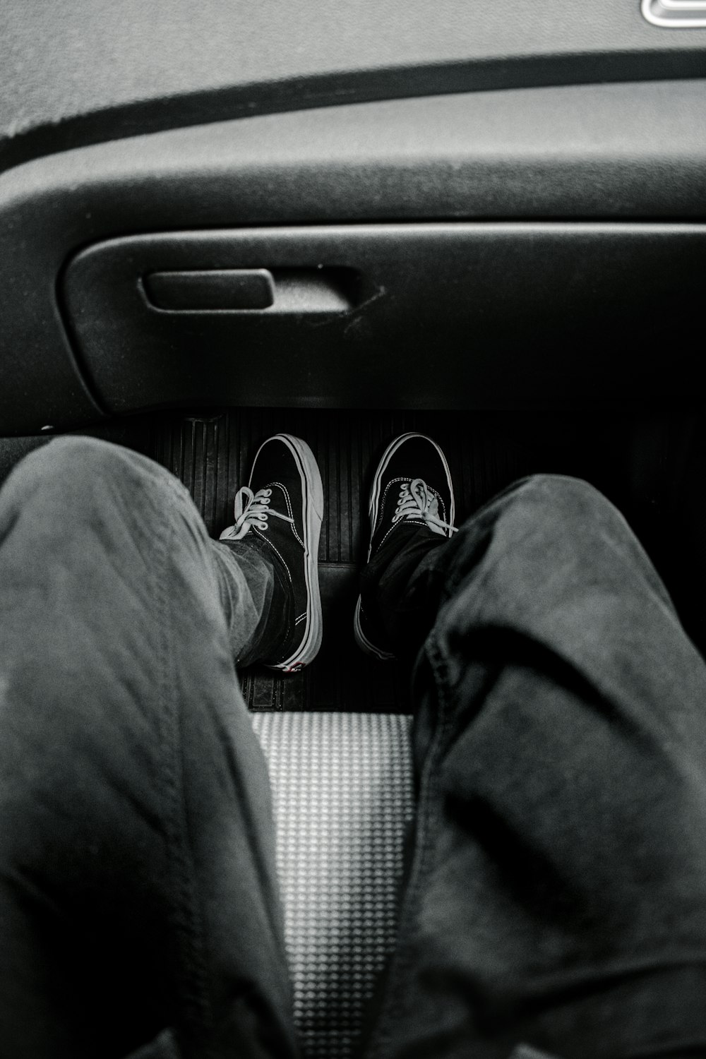 person in black pants and black and white sneakers