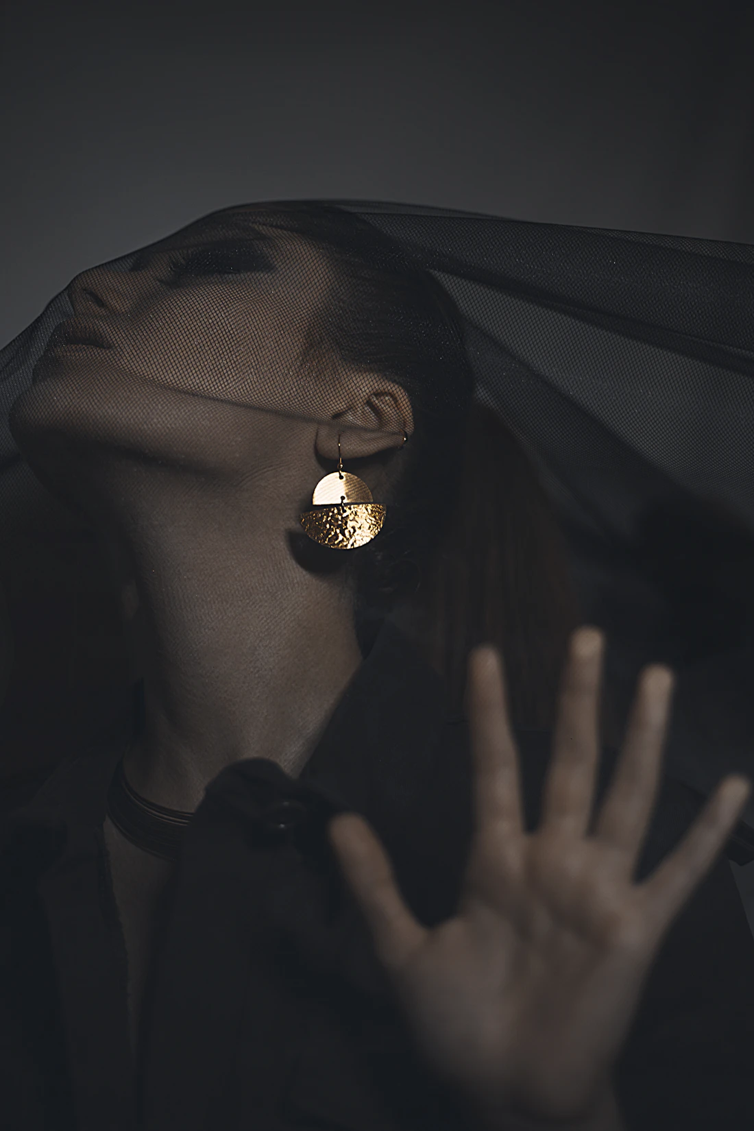 A hand wearing gold, at rest