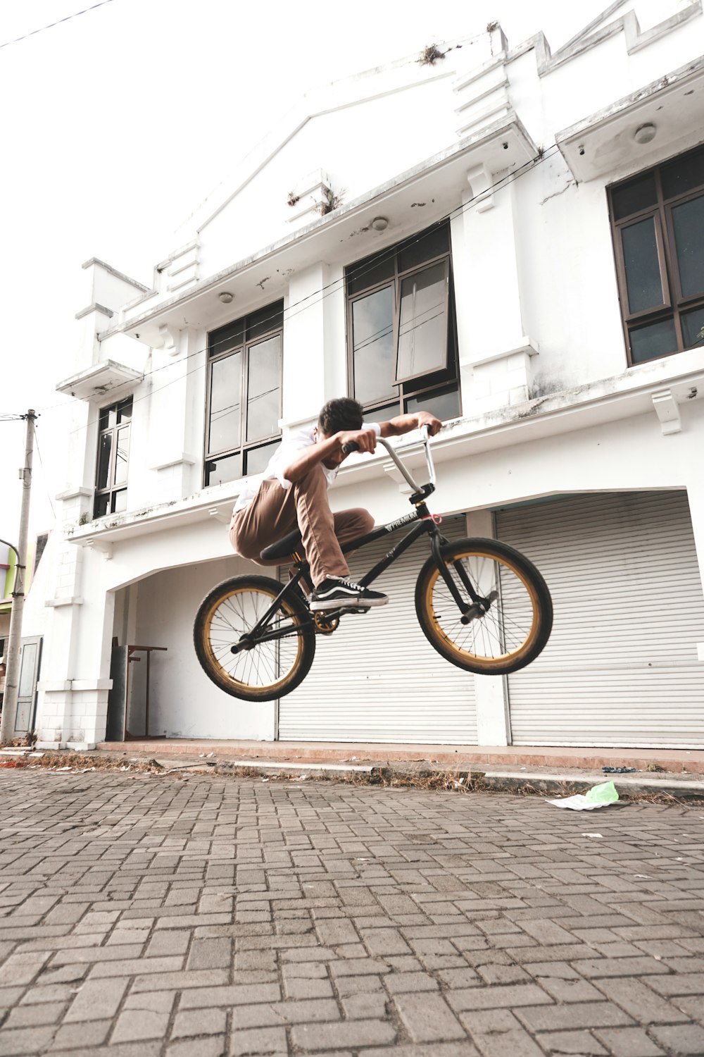 man in black shirt riding on black bmx bike