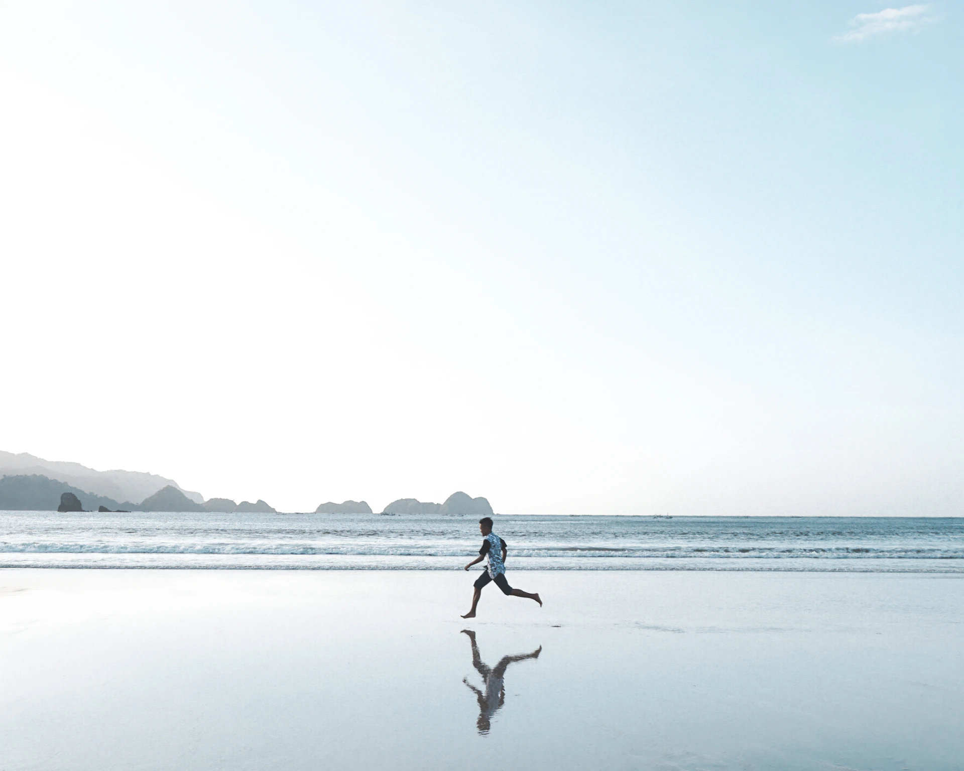 person walking on beach during daytime