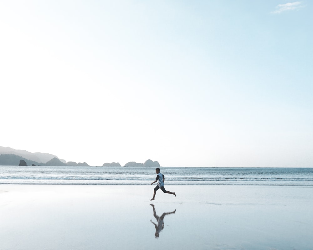 person walking on beach during daytime