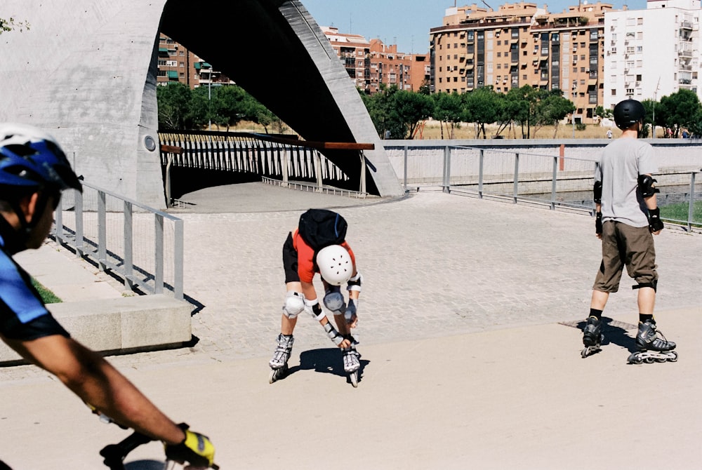 man in white t-shirt and black shorts playing soccer during daytime