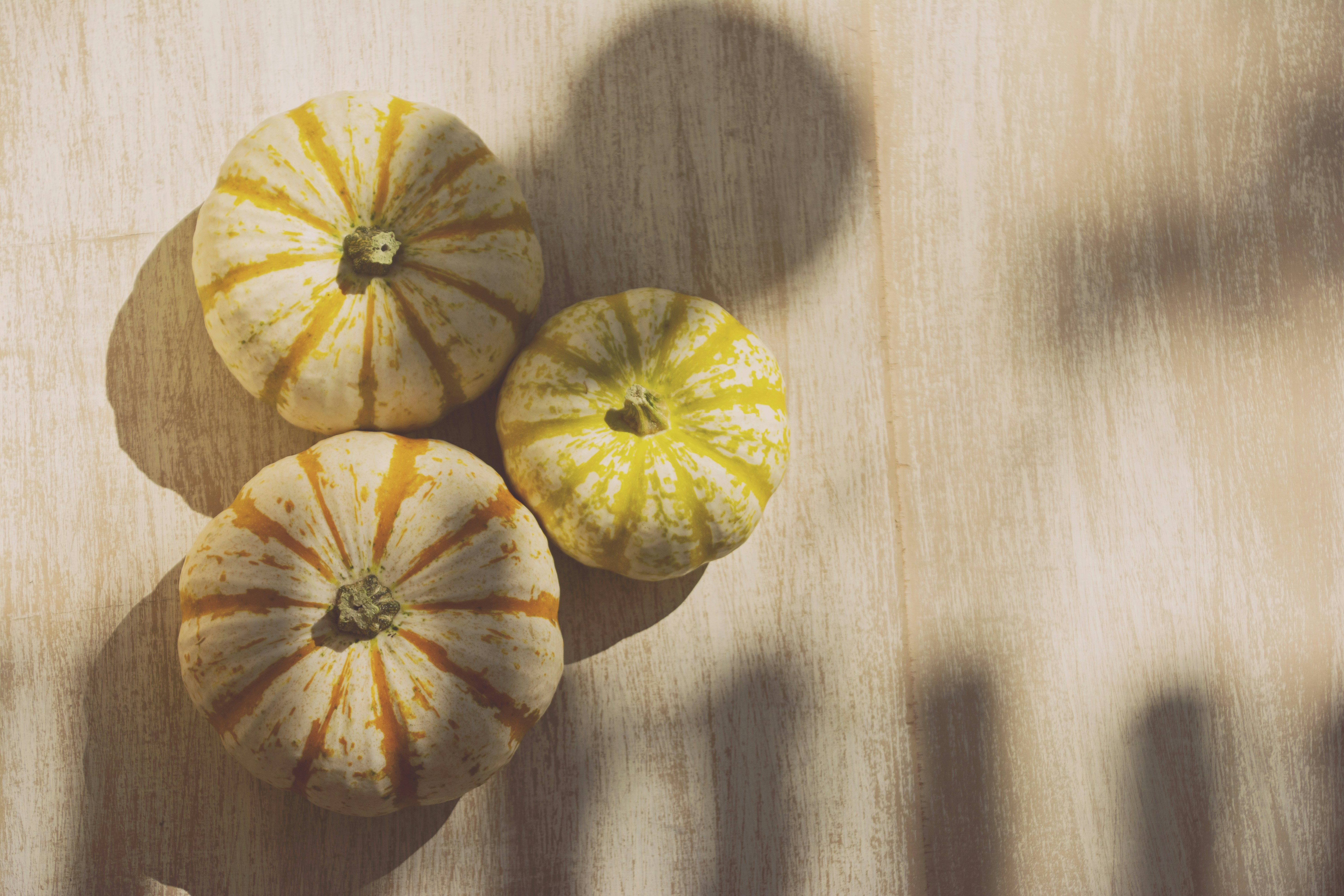 orange pumpkin on brown wooden table
