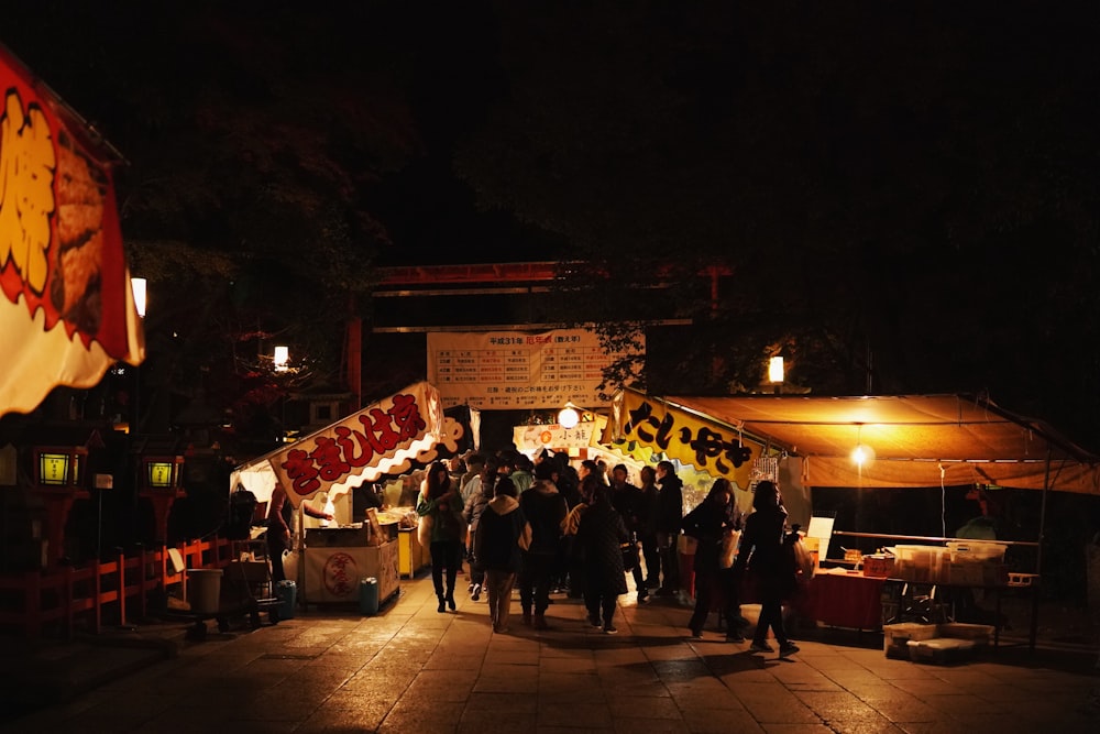 people walking on street during nighttime