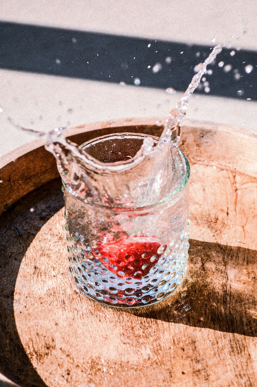 clear glass cup with red liquid